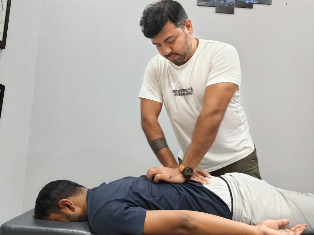 Physiotherapist performing hands-on back therapy at Midas Physiocare